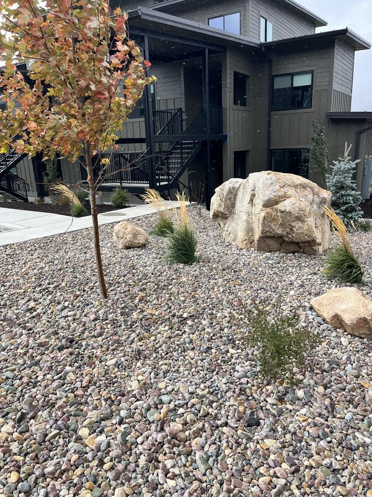 Commercial building landscape with decorative boulders and low-maintenance plantings