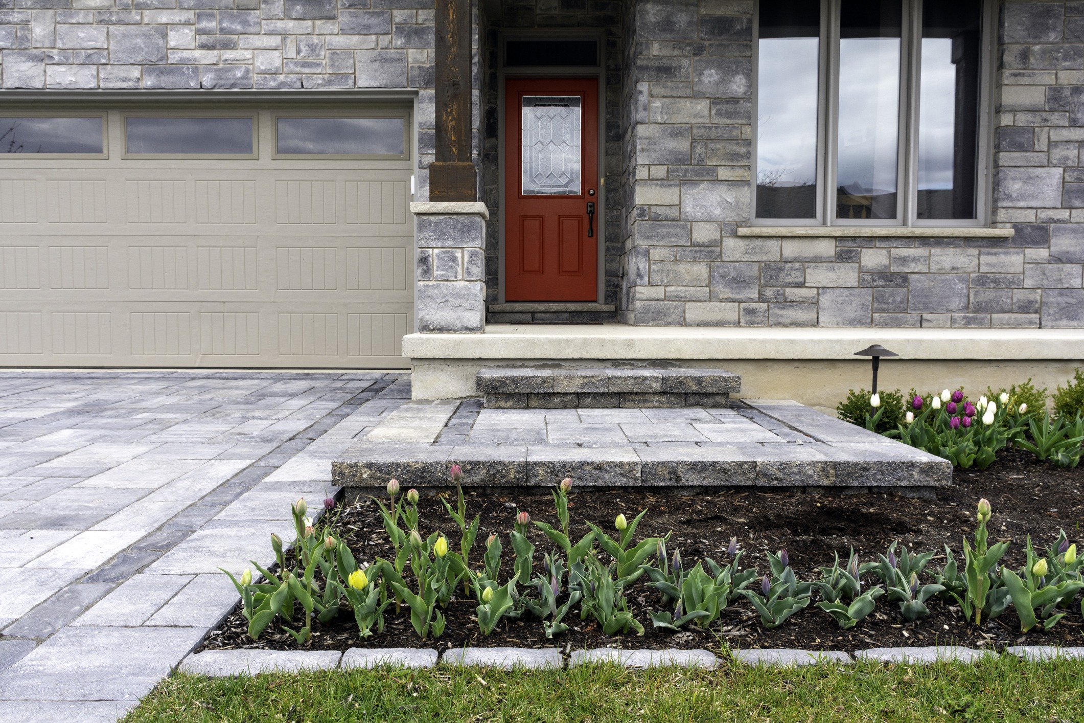 Front yard with tulips and red door