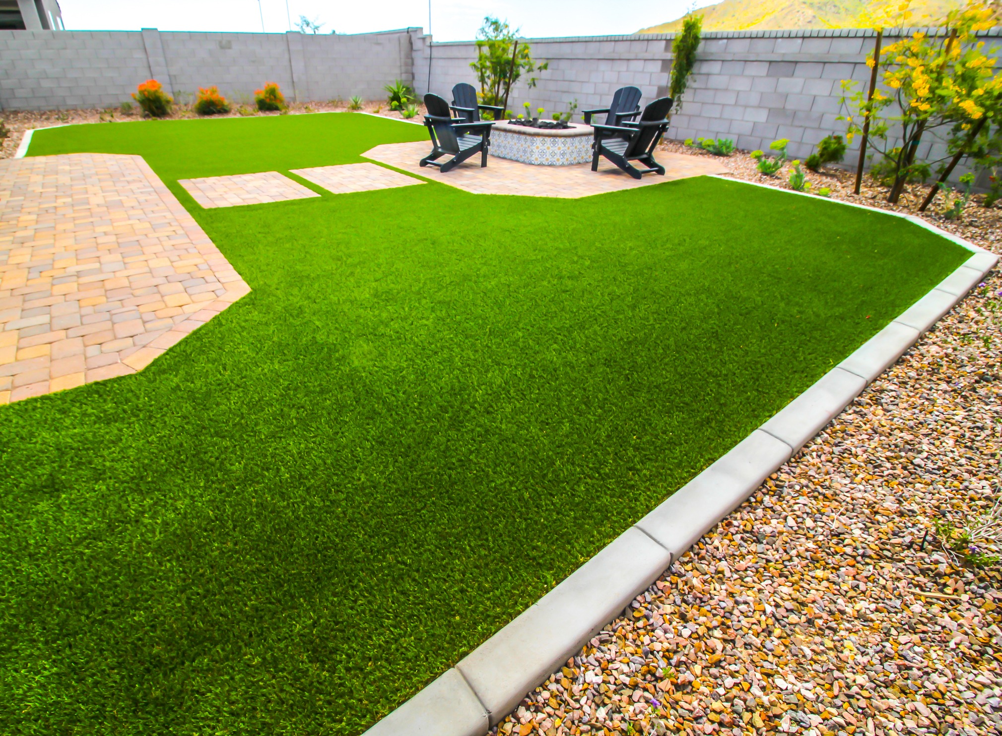 Backyard with artificial grass and patio chairs