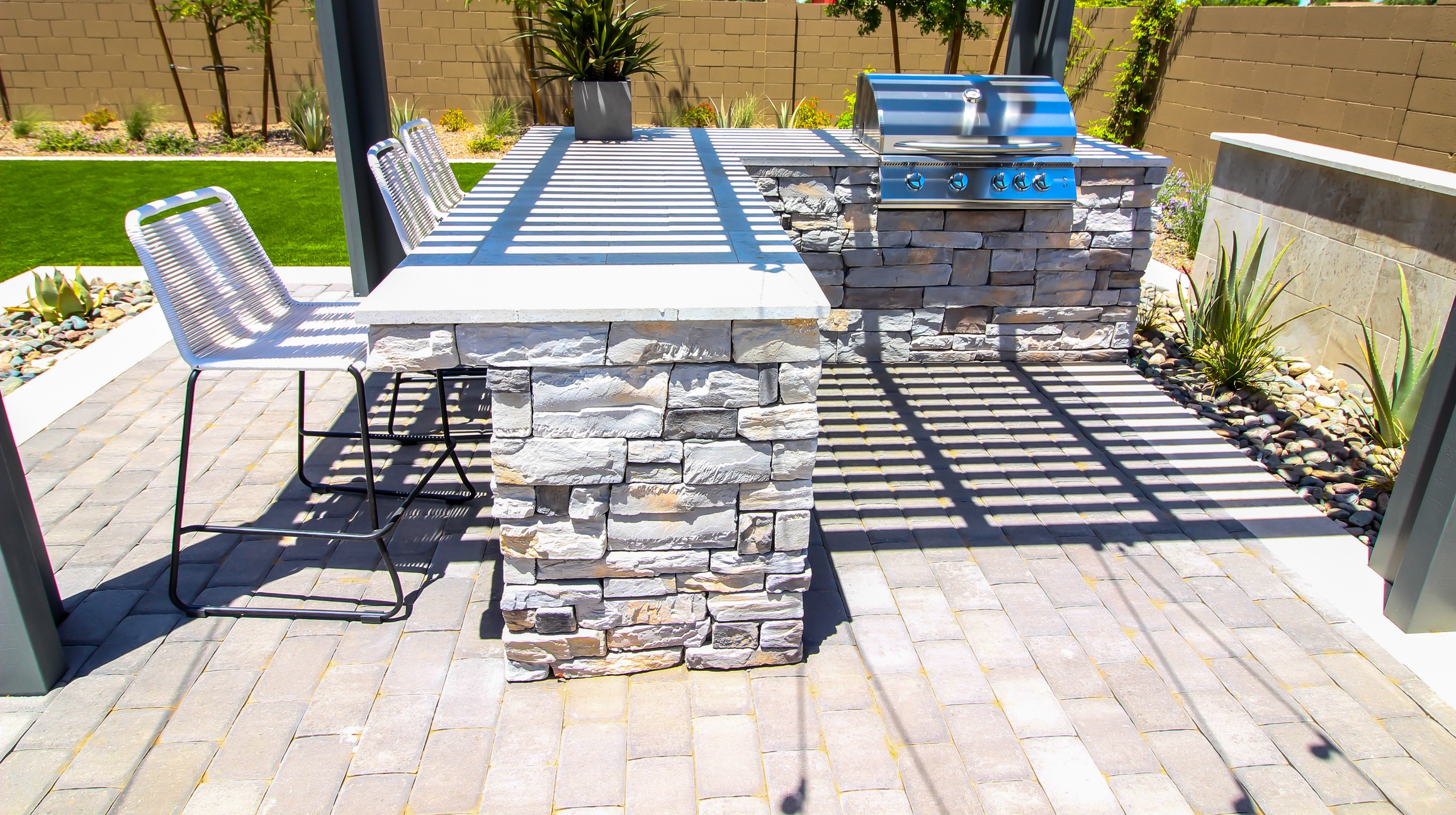 Outdoor kitchen with stone bar and grill