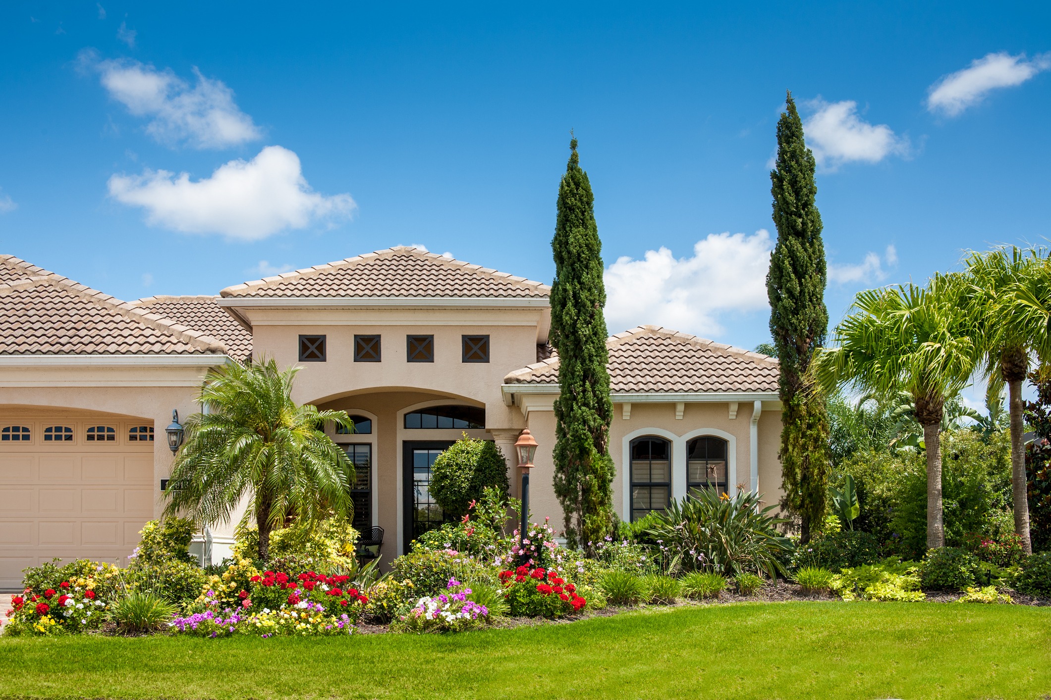 Beautiful house with garden under blue sky.
