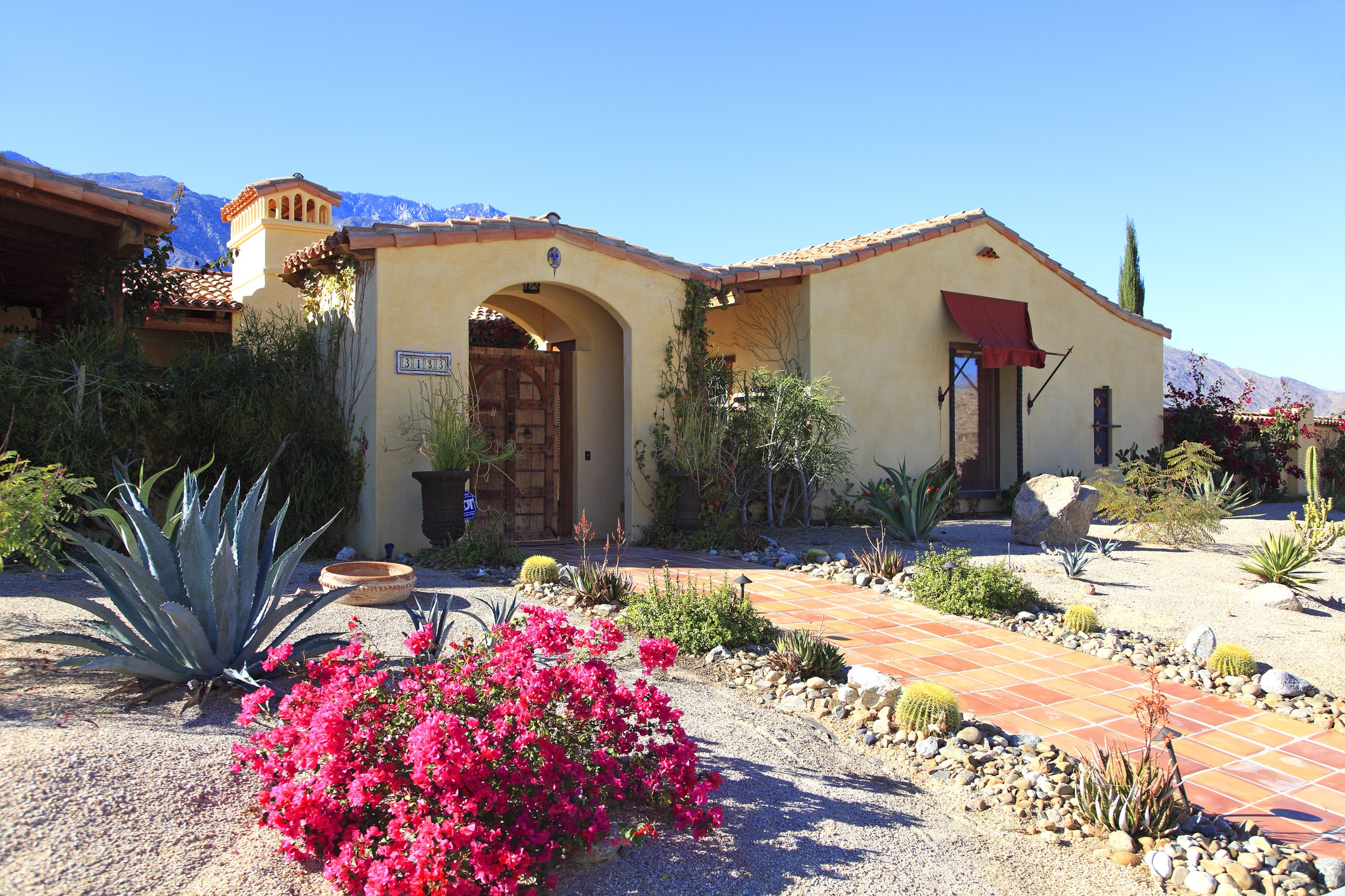 Desert home with garden and mountain backdrop