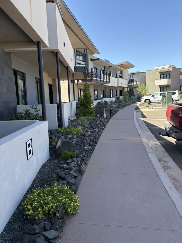 Modern apartment walkway with drought-tolerant commercial landscaping
