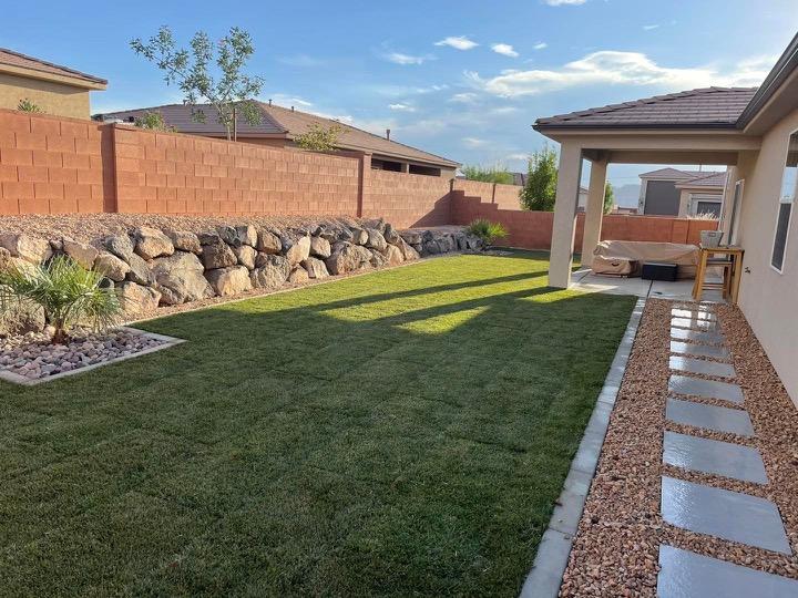 Residential-style lawn with stone edging and low-maintenance landscape design